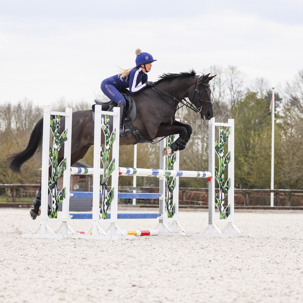 Rider jumping wearing Aubrion Team Winter Baselayer in Navy