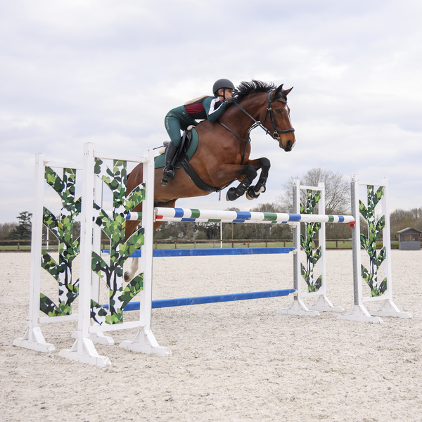 Rider jumping wearing Aubrion Team Winter Baselayer in Green