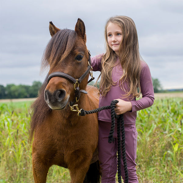Child with pony wearing Cameo Core Collection Baselayer Junior in Damson
