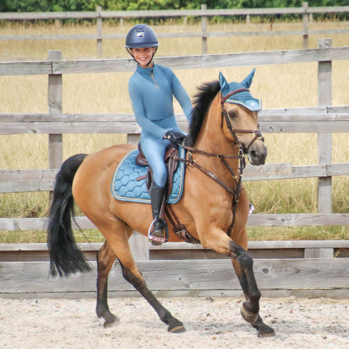 Child riding in Coldstream Next Generation Ednam Base Layer in slate blue