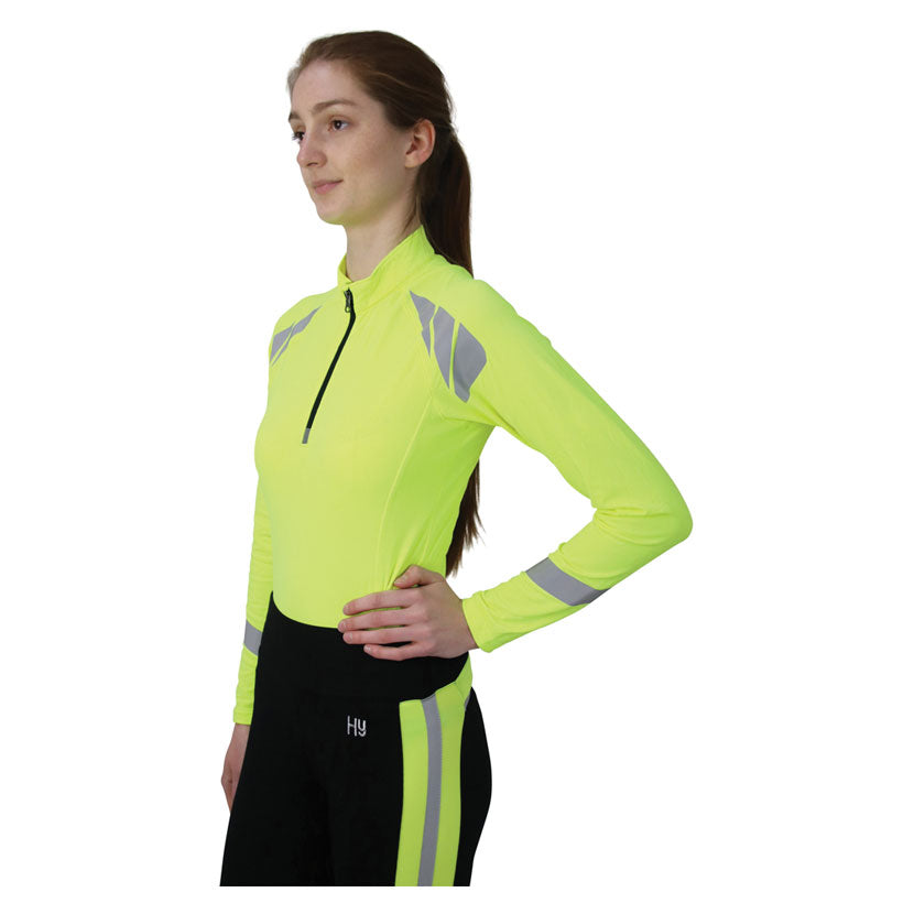 Model wearing Reflector Base Layer by Hy Equestrian in Yellow